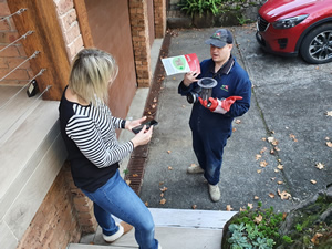 Joel demonstrates a termite bait to our local client 