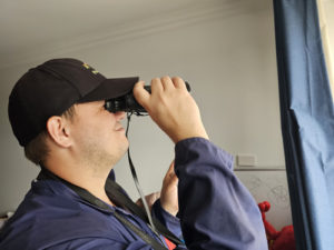 A1 Pest Control Technician Using Binoculars