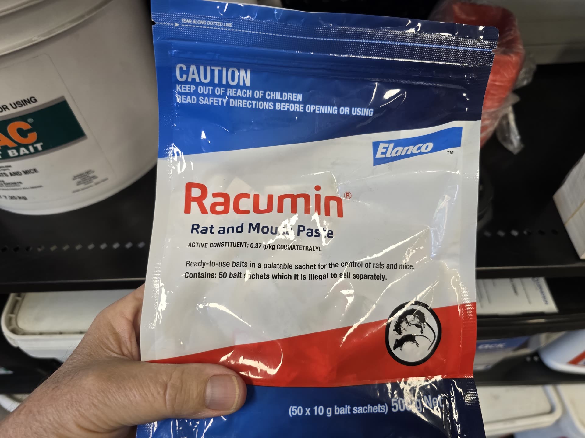 Racumin rat and mouse paste sachet held in hand
